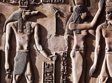 This relief from the Temple of Kom Ombo shows Sobek with typical attributes of kingship, including a was-sceptre and royal kilt. The ankh in his hand represents his role as an Osirian healer and his crown is a solar crown associated with one of the many forms of Ra.