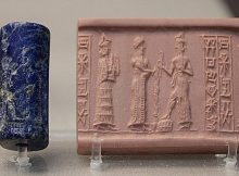 Lapis lazuli cylinder seal. A suppliant goddess (left, with necklace counterweight) stands behind the robed king (center) who pours libation before the ascending sun god who holds the rod and ring of justice and rests his foot on a rectangular chequer-board mountain. Bur-Dagan, son of Kurub-Adad, inscribed on the seal, is probably the name of the owner. From a tomb in Ur, dated c. 1900 BC. BM 121418.