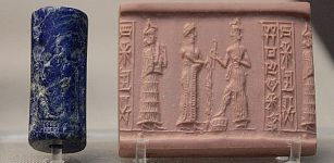 Lapis lazuli cylinder seal. A suppliant goddess (left, with necklace counterweight) stands behind the robed king (center) who pours libation before the ascending sun god who holds the rod and ring of justice and rests his foot on a rectangular chequer-board mountain. Bur-Dagan, son of Kurub-Adad, inscribed on the seal, is probably the name of the owner. From a tomb in Ur, dated c. 1900 BC. BM 121418.