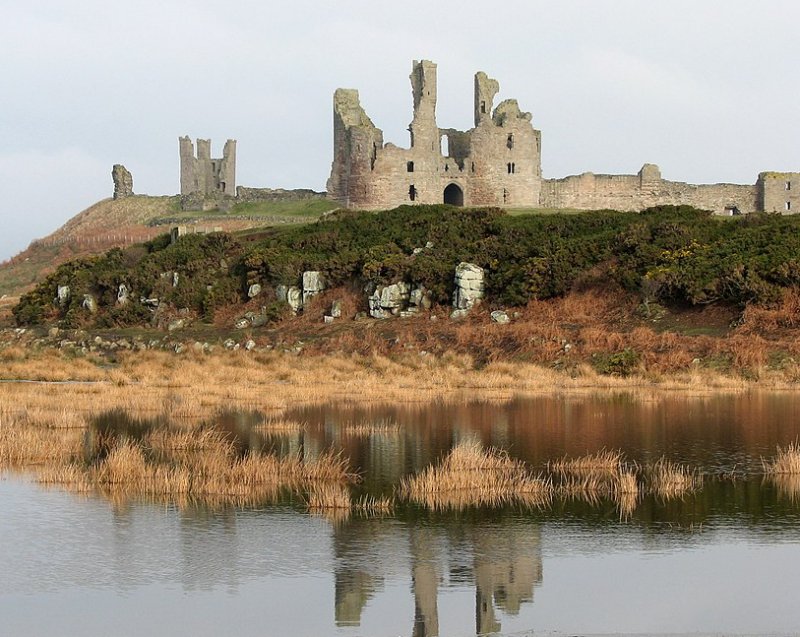 Dunstanburgh Castle, reflected in the remains of the southern mere