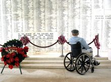 Pearl Harbor survivor Bill Johnson reads the list of names inscribed in the USS Arizona Memorial.