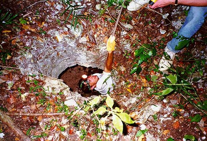 An archaeologist investigating a chultun