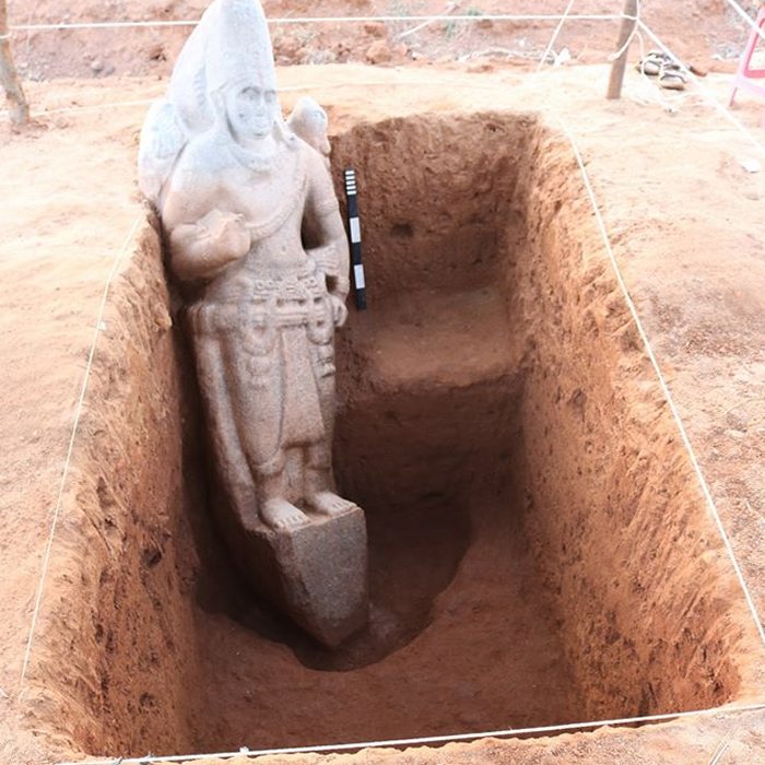 a 4-armed Vishnu standing over a pedestal carrying chakra and conch in his upper right and left hands. The lower right is in bestowing boon and the left hand in katihastha (resting on the hip) posture. The iconographical feature like the elaborate head gear, thick holy thread and decorative drapery dates the Vishnu idol to Pallava period (circa 8th cent. CE).