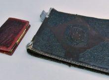 The photo album is pictured with a notebook. (Courtesy of Auschwitz Memorial Museum)