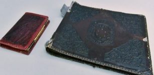 The photo album is pictured with a notebook. (Courtesy of Auschwitz Memorial Museum)