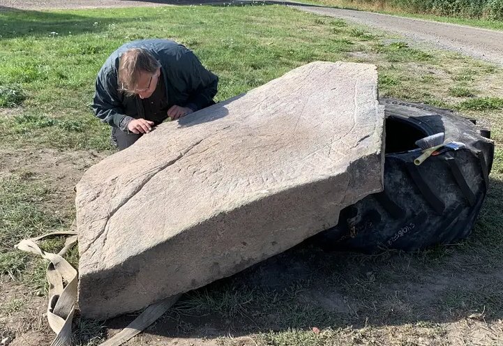 Unique Viking Age Runestone With A Cross And Animal Biting Its Own Tail Discovered By Farmer In Sweden