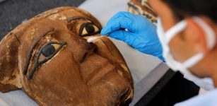 An archaeologist works on an artifact, around 2,500 years old, from the newly discovered burial site near Egypt's Saqqara necropolis, during a presentation in Giza, Egypt November 14, 2020. REUTERS