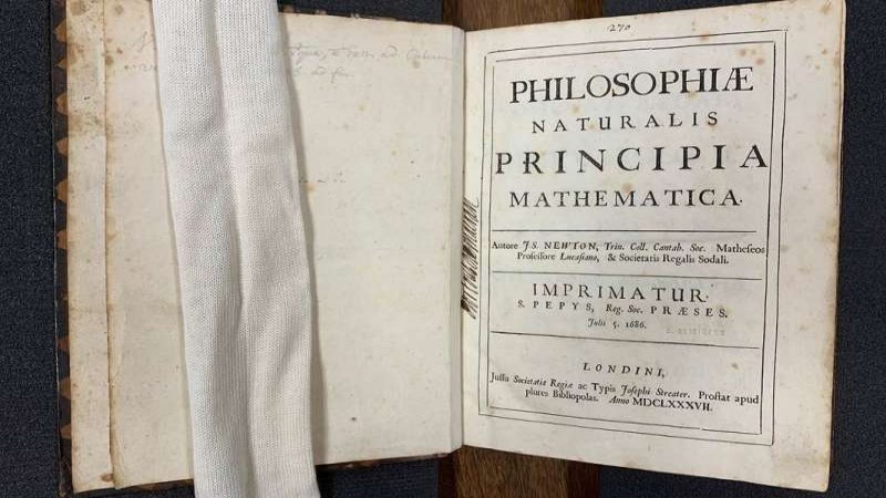 Caltech's own copy of the first edition of the Principia is part of the Institute's Archives and Special Collections. In the 18th century, it belonged to French mathematician and natural philosopher Jean-Jacques d'Ortous de Mairan, whose signature can be seen in the left margin of the title page. The white "snake" seen at left helps hold the pages down. Credit: Caltech Archives